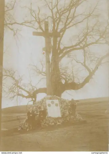 A5940 people gathered at the base of a large wooden cross, placed on a mound of stones