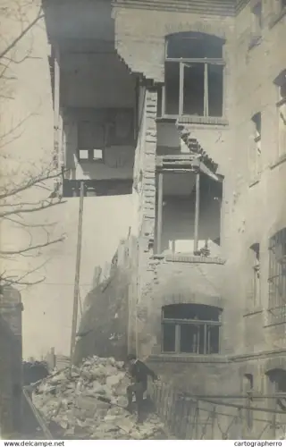 A5974 Photographic postcard damaged building place to identify
