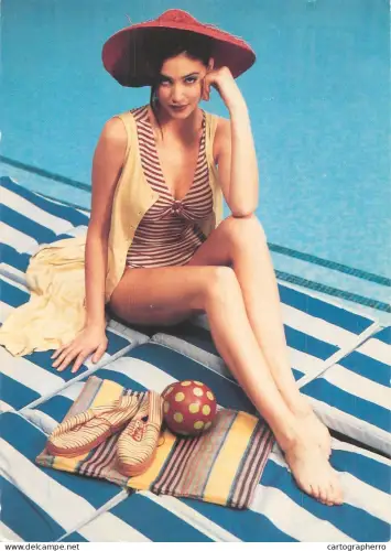 A6099 Woman posing in a striped one-piece swimsuit, suggesting a vintage-style fashion brand