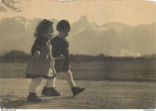 A6099 Postcard two young children walking together outdoors