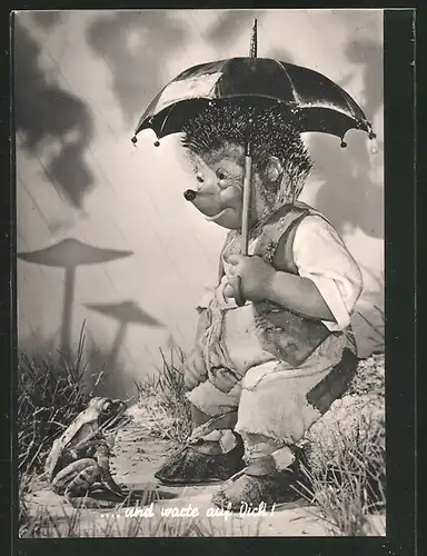 AK Mecki sitzt im Regen mit Regenschirm und unterhält sich mit einem Frosch