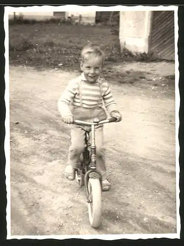 Fotografie fröhliches Kind fährt Fahrrad