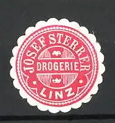 Präge-Reklamemarke Drogerie Josef Sterrer zu Linz, rot