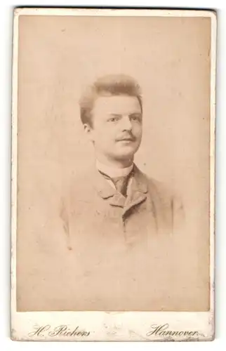 Fotografie H. Richers, Hannover, Portrait junger charmanter Mann mit Krawatte im eleganten Jackett