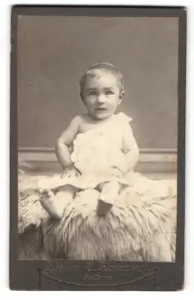 Fotografie Atelier C. Römmert, Helbra, Baby auf einem Fell sitzend
