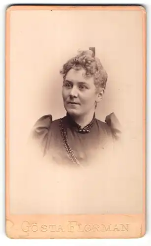 Fotografie Gösta Florman, Stockholm, Portrait Frau mit zurückgebundenem Haar in einem Kleid mit Puffärmeln