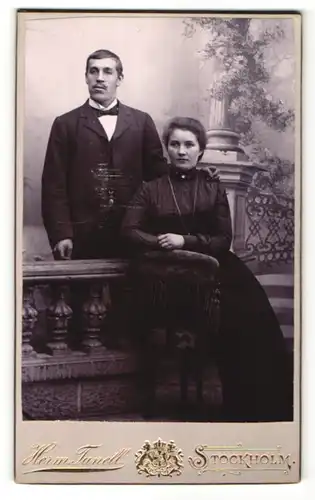 Fotografie Herm. Tunell, Stockholm, Portrait traumhaft schönes Paar in eleganter dunkler Kleidung