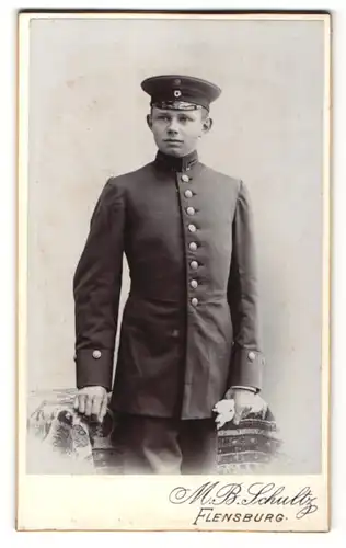 Fotografie M. B. Schultz, Flensburg, Portrait junger Briefträger in Dienstkleidung