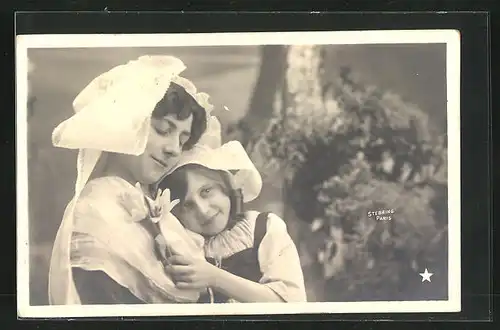 Foto-AK Stebbing: Lächelnde junge Dame mit Haube mit kleinem Mädchen im Arm