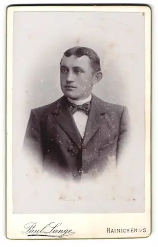 Fotografie Paul Lange, Hainichen i. S., Portrait brünetter junger Mann mit Scheitel und Fliege im Jackett