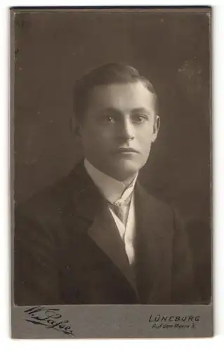 Fotografie W. Safse, Lüneburg, junger Herr mit Stehkragen und Seitenscheitel in Dreiteiler mit Krawatte