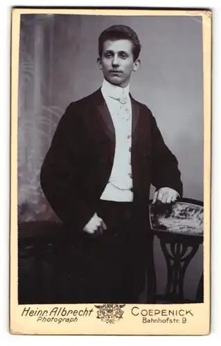 Fotografie Heinr. Albrecht, Berlin-Köpenick, Portrait dunkelhaariger junger Mann im schwarzen Anzug