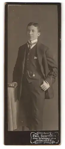 Fotografie Emil Schröter, Berlin-Spandau, Portrait junger Herr im Anzug an Tisch gelehnt