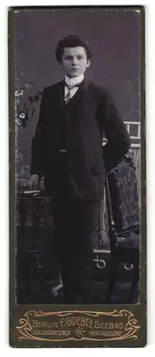 Fotografie F. Goebel, Berlin, Portrait dunkelhaariger Knabe mit Buch im eleganten Anzug