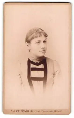 Fotografie Albert Grundner, Berlin, Portrait junge Dame im modischen Kleid mit Kragenbrosche