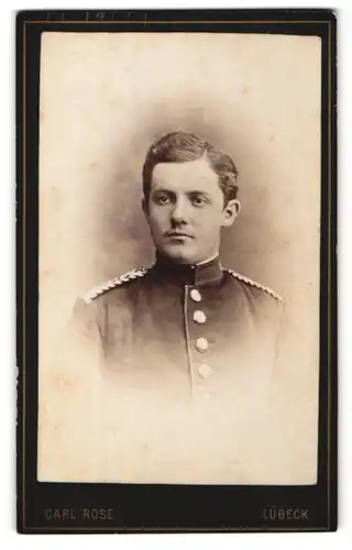 Fotografie Carl Rose, Lübeck, Portrait Soldat in Uniform mit Schulterklappen mit Paspelierung