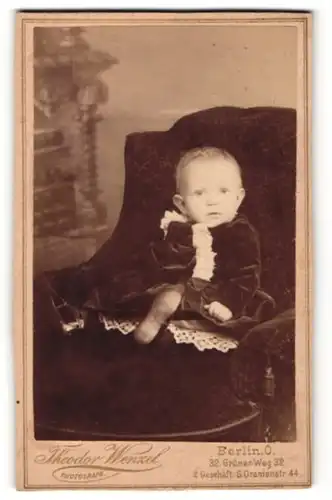 Fotografie Theodor Wenzel, Berlin, Baby in dunklem Kleid mit heller Spitze