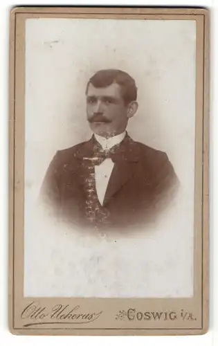 Fotografie Otto Uekerus, Coswig i. A., Portrait eleganter Herr im Anzug mit Zwirbelbart