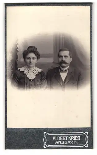 Fotografie Albert Krieg, Ansbach, Mann im Anzug mit Fliege und Schauzer und Frau mit Dutt