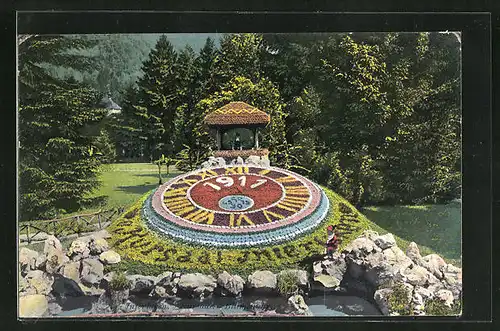 AK Blumenuhr mit Jahreszahl 1911 in einem Park
