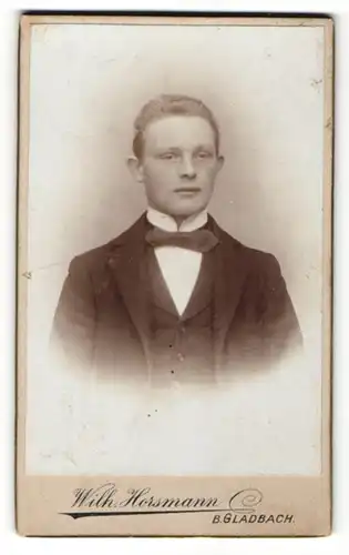 Fotografie Wilhelm Horsmann, Gladbach, Portrait junger Mann mit blondem Haar und Fliege im Jackett