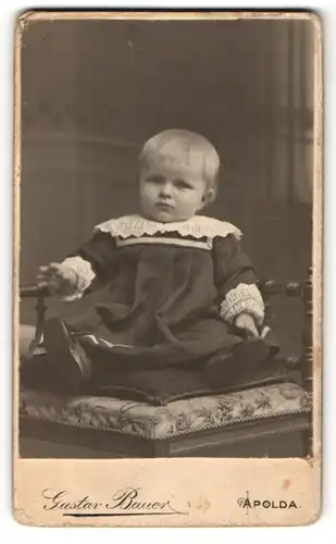Fotografie Gustav Bauer, Apolda, Baby im Kleid sitzend auf einem Stuhl