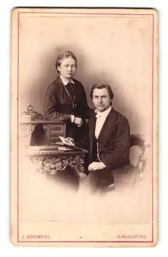 Fotografie J. Kosmehl, Magdeburg, Portrait elegant gekleidetes Paar am Tisch sitzend