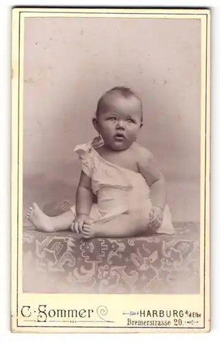 Fotografie C. Sommer, Harburg a / d. Elbe, Portrait niedliches Kleinkind im weissen Hemd auf Tisch sitzend