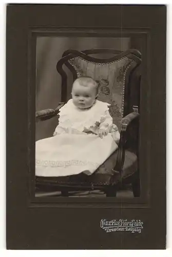 Fotografie Martin Herzfelde, Dresden-Leipzig, Portrait niedliches Baby im weissen Kleid auf Stuhl sitzend