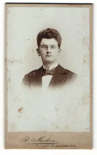 Fotografie R. Martens, Flensburg, Portrait dunkelhaariger junger Mann mit Zwicker