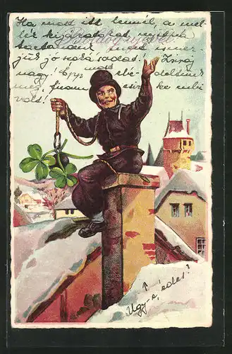 AK Schornsteinfeger sitzt auf dem Dach und holt Glücksklee aus dem Schornstein