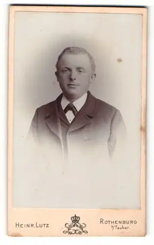 Fotografie Heinrich Lutz, Rothenburg, Portrait Mann mit kurzen Haaren im Anzug mit Fliege