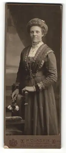 Fotografie P. Clasen, Dessau, Portrait charmant blickende Dame im prachtvollen Kleid