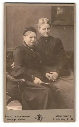 Fotografie Franz Langhammer, Magdeburg, Portrait zwei sitzende Damen in zeitgenössischer Kleidung mit Buch
