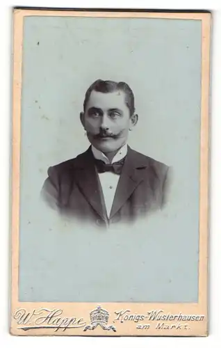 Fotografie W. Happe, Königs-Wusterhausen, Portrait junger Herr im Anzug mit Fliege und Schnauzbart
