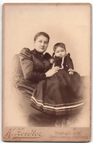 Fotografie H. Zeidler, Berlin-SW, Portrait elegant gekleidete Dame mit Baby im Arm