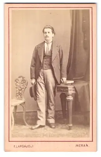 Fotografie F. Largajoli, Meran, Landstrasse, Mann im Anzug mit Hut in der Hand