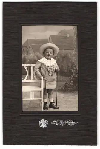 Fotografie Gustav Kneisel, Plauen i. Vogtl., Portrait kleiner Junge in modischer Kleidung mit Stock