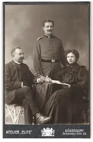 Fotografie Atelier Elite, Düsseldorf, Schadow-Str. 62, Portrait Soldat in Uniform Rgt. 27 nebst Vater und Frau