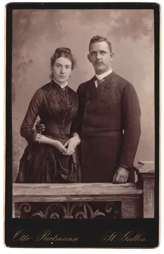 Fotografie Otto Rietmann, St. Gallen, Portrait Paar im Anzug mit Krawatte und Frau im dunklen Kleid
