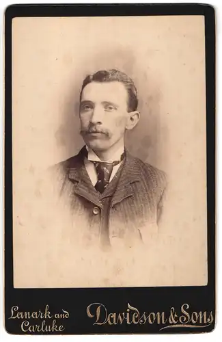 Fotografie Davidson & Sons, Lanark, Portrait junger Mann im Anzug mit Krawatte
