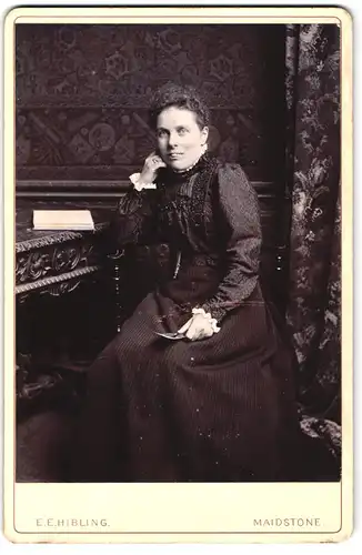Fotografie E. E. Hibling, Maidstone, 125, Week St., Portrait bürgerliche Dame mit Buch am Tisch sitzend