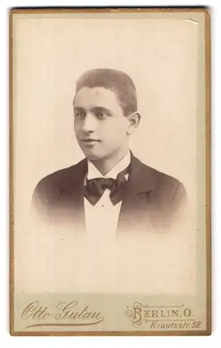 Fotografie Otto Gutau, Berlin, Krautsstr. 52, Portrait junger charmanter Mann in Fliege und Jackett