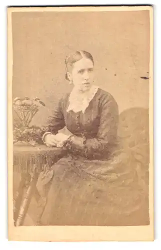Fotografie F. W. Evans, London-SE, 246, Old Kent Road, Portrait bürgerliche Dame am Tisch sitzend
