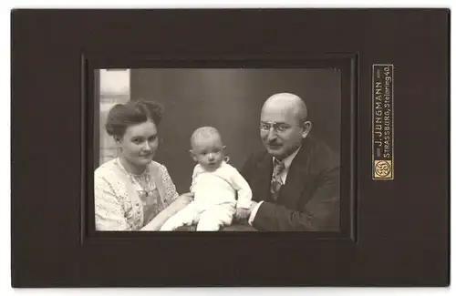 Fotografie J. Jungmann, Strassburg, Steinring 40, Portrait bürgerliches Paar mit einem Baby