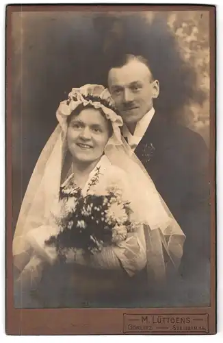 Fotografie M. Lüttgens, Görlitz, Steinstrasse 14, Portrait junges Paar in Hochzeitskleidung mit Blumenstrauss