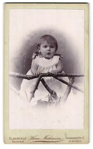 Fotografie Herm. Mochmann, Elberfeld, Casinogarten-Strasse 17, Portrait kleines Mädchen im weissen Kleid