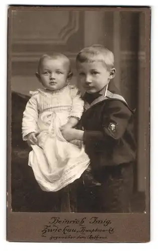 Fotografie Heinrich Imig, Zwickau i /S., Hauptmarkt 15, Portrait kleiner Junge im Matrosenhemd mit Kleinkind an der Hand