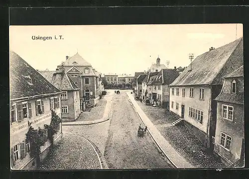 AK Usingen i. T., Strassenpartie mit Kirche