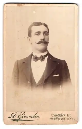 Fotografie A. Giesecke, Hannover, Welfenplatz 16a, Portrait adretter Mann im Anzug mit Moustache und Fliege